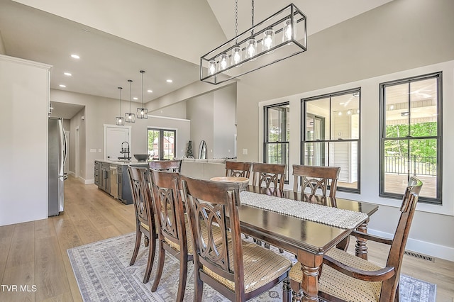 dining space with baseboards, light wood finished floors, recessed lighting, and visible vents