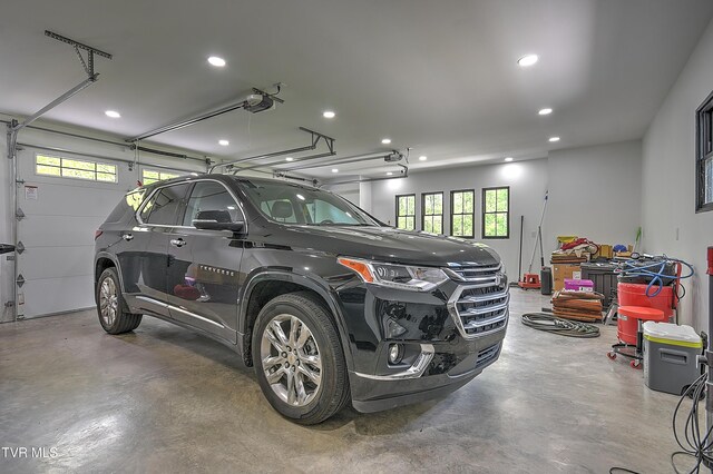 garage with recessed lighting and a garage door opener