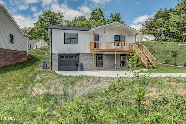 rear view of property with central air condition unit, stairs, a deck, concrete driveway, and a garage