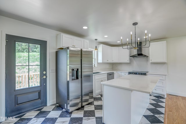 kitchen with light countertops, a center island, stainless steel appliances, wall chimney range hood, and recessed lighting