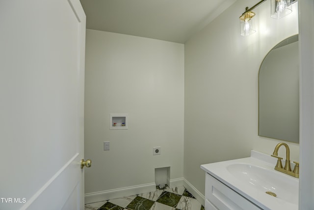 bathroom featuring baseboards, marble finish floor, and vanity