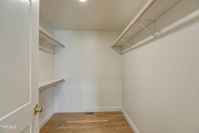 spacious closet with visible vents and light wood-type flooring