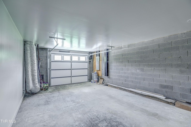 garage with concrete block wall