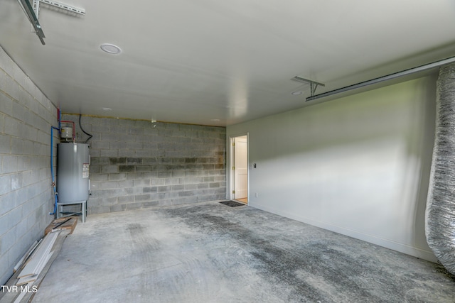 garage with water heater and concrete block wall