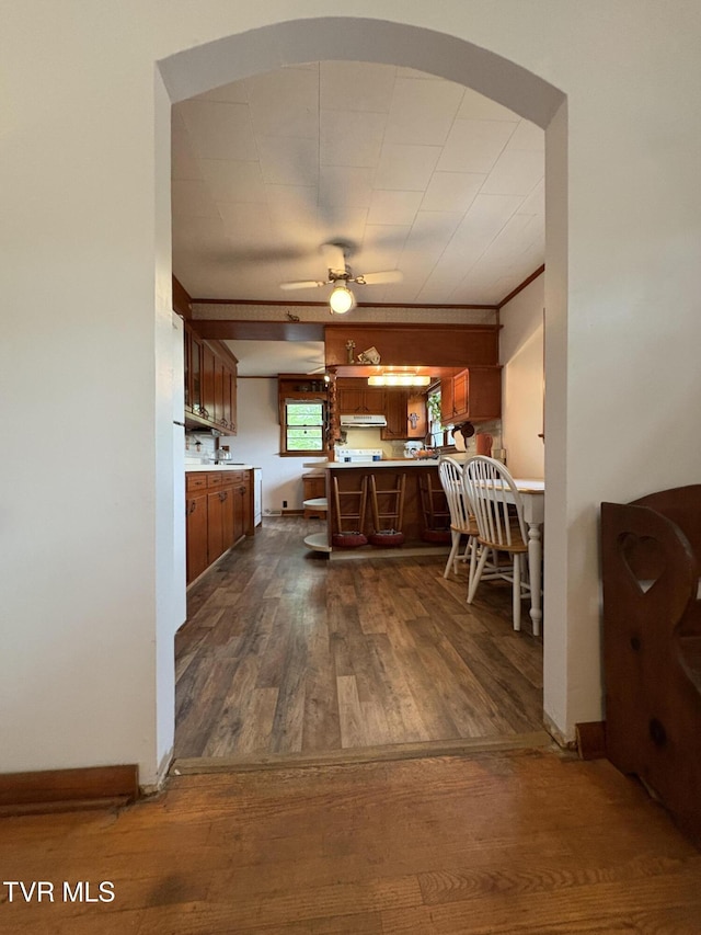 211 Arthur G Caudill Rd, West Jefferson, NC 28694 - kitchen featuring a peninsula, dark wood-style flooring, light countertops, a ceiling fan, and a breakfast bar area