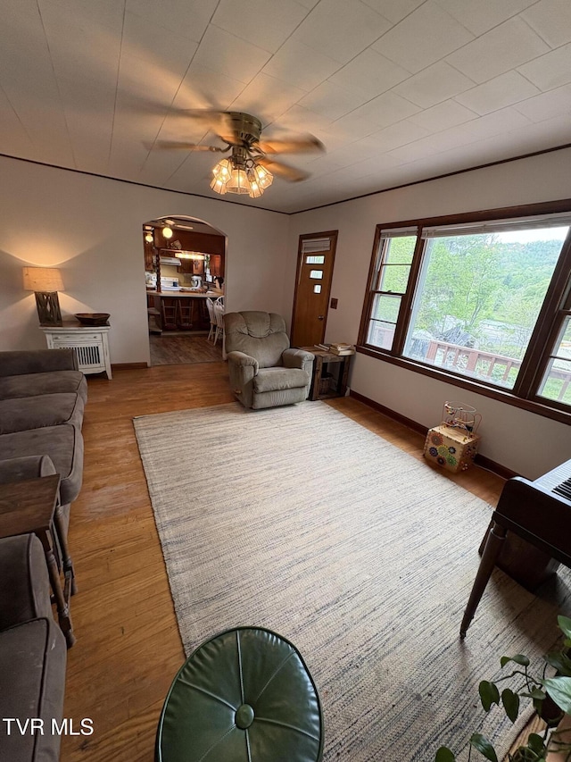 211 Arthur G Caudill Rd, West Jefferson, NC 28694 - living area with wood finished floors, a ceiling fan, arched walkways, and baseboards