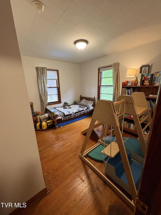 211 Arthur G Caudill Rd, West Jefferson, NC 28694 - bedroom with multiple windows and wood-type flooring