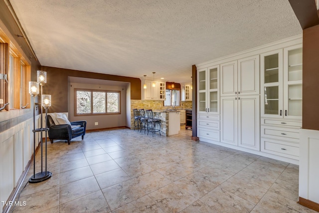 living area featuring a textured ceiling