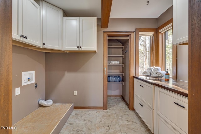 washroom with cabinet space, baseboards, electric dryer hookup, and hookup for a washing machine