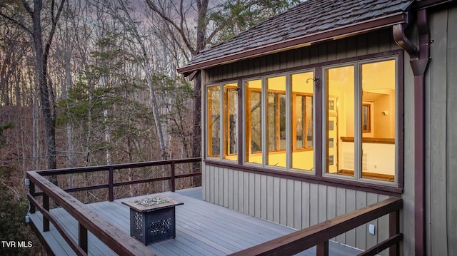 wooden terrace featuring an outdoor fire pit