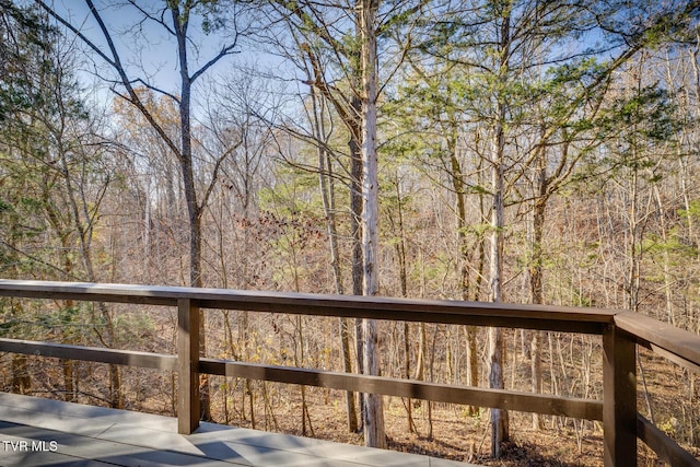 wooden deck with a forest view