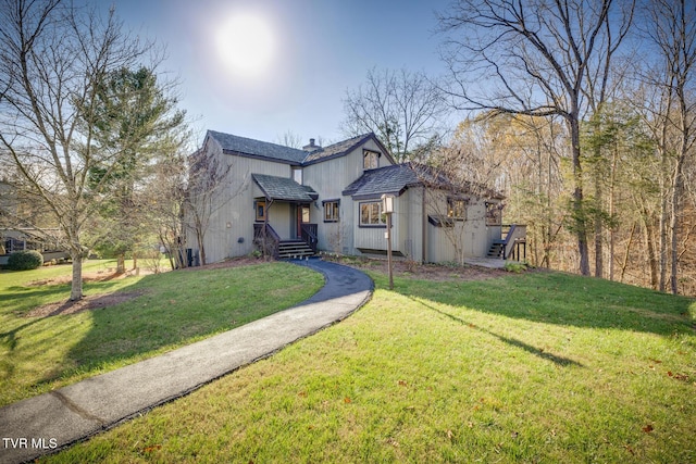 traditional home featuring a chimney and a front yard