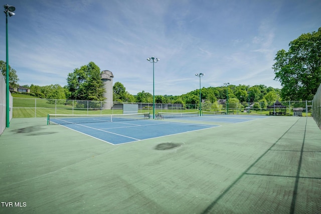 view of tennis court with fence