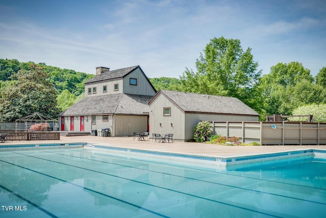 pool featuring an outdoor structure and fence