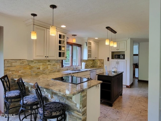 137 Columbine Rd, Kingsport, TN 37660 - kitchen featuring black electric cooktop, a sink, tasteful backsplash, a peninsula, and dark stone countertops