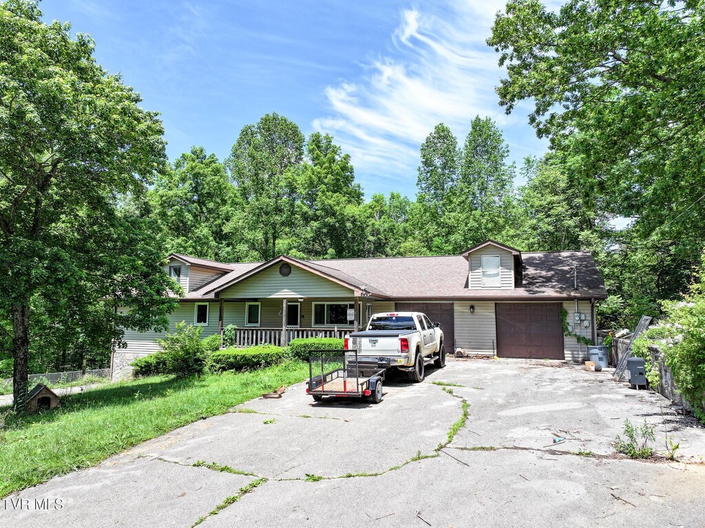 4240 Chavis Rd, Cosby, TN 37722 - view of front of home with an attached garage, asphalt driveway, and covered porch