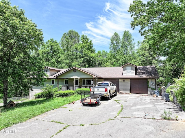 4240 Chavis Rd, Cosby, TN 37722 - view of front of home with an attached garage, asphalt driveway, and covered porch