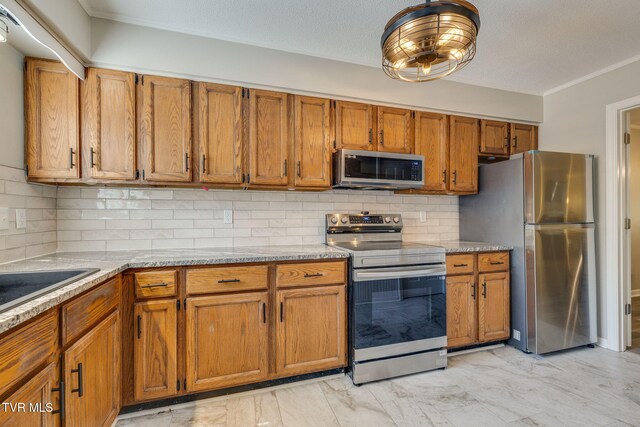1127 Timbers E ., Unit Greeneville, TN 37745 - kitchen with appliances with stainless steel finishes, brown cabinets, ornamental molding, tasteful backsplash, and light marble finish flooring
