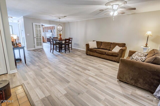 1127 Timbers E ., Unit Greeneville, TN 37745 - living area with ceiling fan, light wood-style flooring, and baseboards