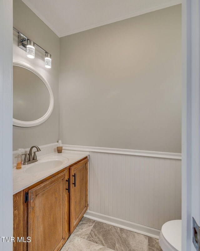 1127 Timbers E ., Unit Greeneville, TN 37745 - bathroom with vanity, a wainscoted wall, and toilet
