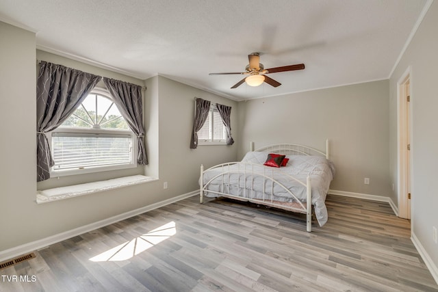 1127 Timbers E ., Unit Greeneville, TN 37745 - bedroom featuring ornamental molding, wood finished floors, baseboards, a textured ceiling, and ceiling fan