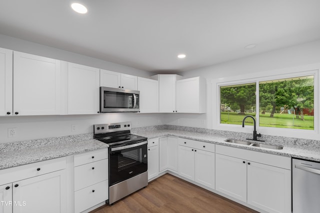 2503 Buffalo Rd, Johnson City, TN 37604 - kitchen with appliances with stainless steel finishes, a sink, white cabinetry, recessed lighting, and wood finished floors