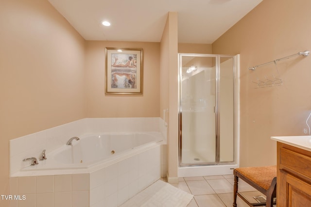 full bath with vanity, a stall shower, tile patterned floors, and a jetted tub