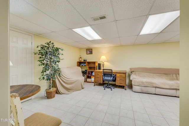 office area with a paneled ceiling