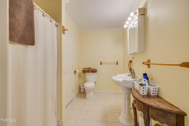 bathroom featuring crown molding, a textured ceiling, tile patterned flooring, toilet, and baseboards