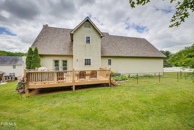 rear view of property featuring roof with shingles and a wooden deck