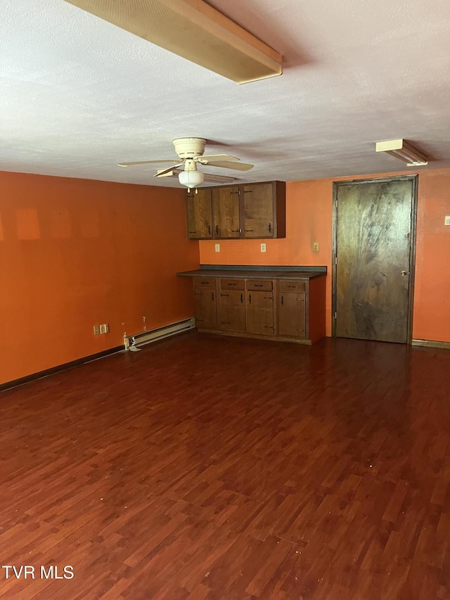 6430 Hoot Owl Hollow Rd, Norton, VA 24273 - interior space with a ceiling fan, baseboards, dark wood-style flooring, and a baseboard radiator
