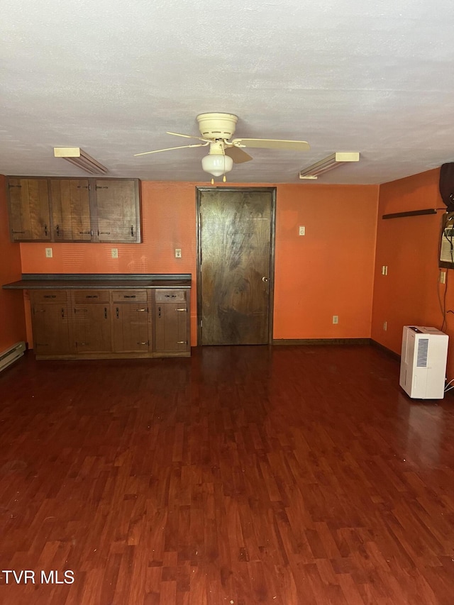 6430 Hoot Owl Hollow Rd, Norton, VA 24273 - kitchen featuring baseboards, dark wood-style flooring, dark countertops, and ceiling fan