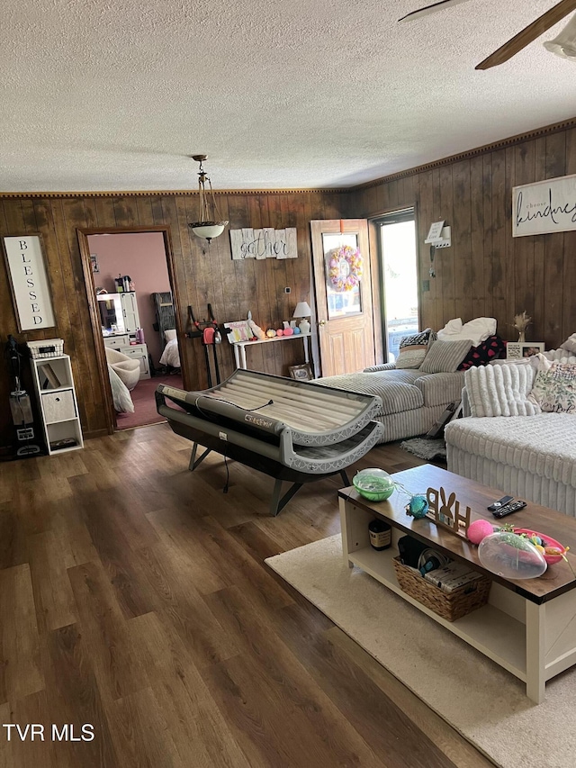 6430 Hoot Owl Hollow Rd, Norton, VA 24273 - living room with wood walls, a textured ceiling, and wood finished floors