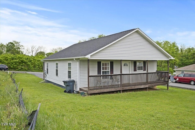 view of front of house with a porch, roof with shingles, and a front yard