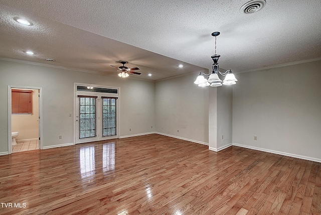 33 Oak Leaf Cir Unit 33, Johnson City, TN 37601 - empty room featuring ornamental molding, wood finished floors, a textured ceiling, a chandelier, and a ceiling fan