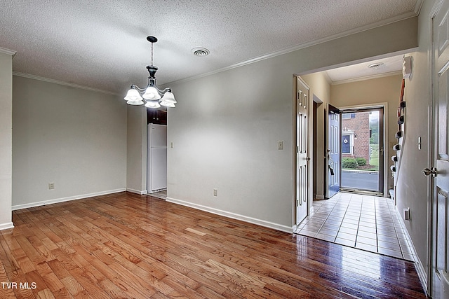 33 Oak Leaf Cir Unit 33, Johnson City, TN 37601 - empty room with wood finished floors, a chandelier, baseboards, crown molding, and a textured ceiling