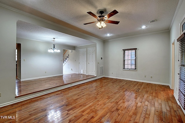 33 Oak Leaf Cir Unit 33, Johnson City, TN 37601 - unfurnished living room featuring a textured ceiling, ceiling fan, light wood finished floors, crown molding, and a chandelier