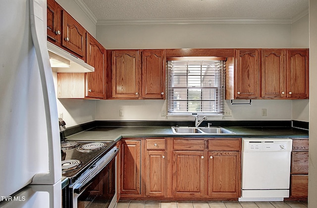 33 Oak Leaf Cir Unit 33, Johnson City, TN 37601 - kitchen with white appliances, a sink, dark countertops, brown cabinets, and crown molding