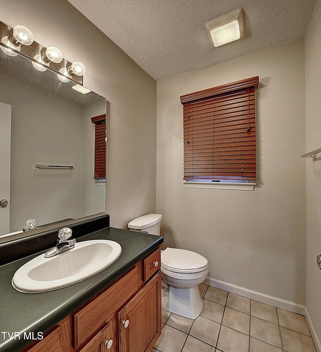 33 Oak Leaf Cir Unit 33, Johnson City, TN 37601 - bathroom with tile patterned floors, toilet, vanity, baseboards, and a textured ceiling
