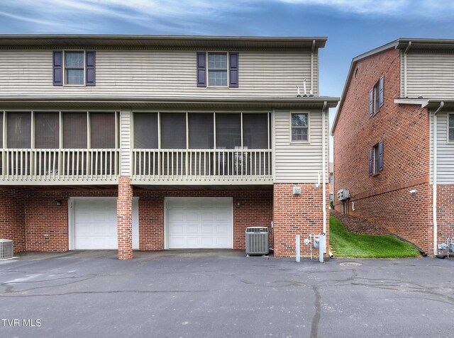 33 Oak Leaf Cir Unit 33, Johnson City, TN 37601 - rear view of house with central AC unit, an attached garage, driveway, and brick siding