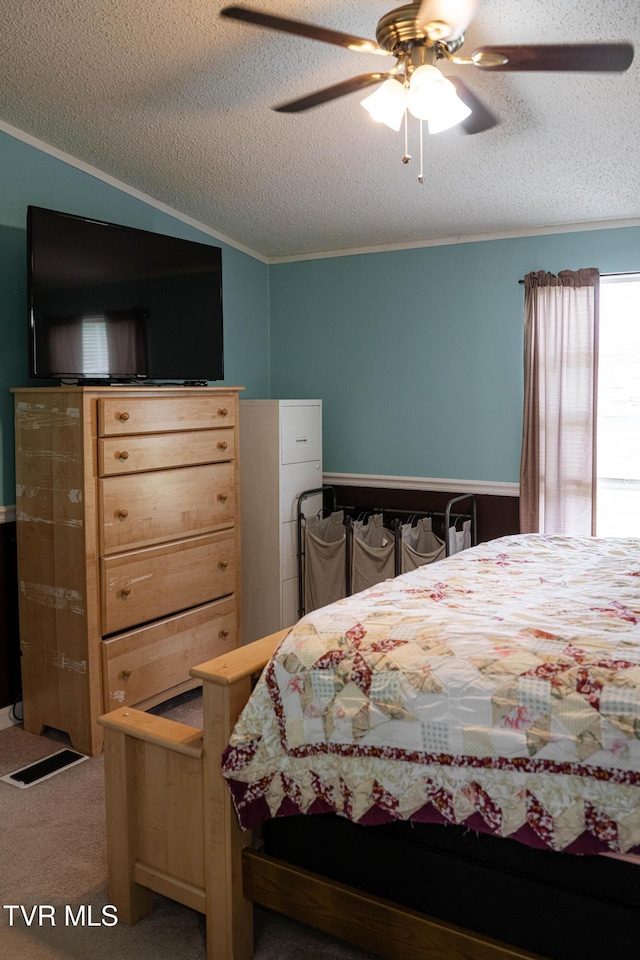 bedroom featuring ornamental molding, a textured ceiling, and carpet flooring