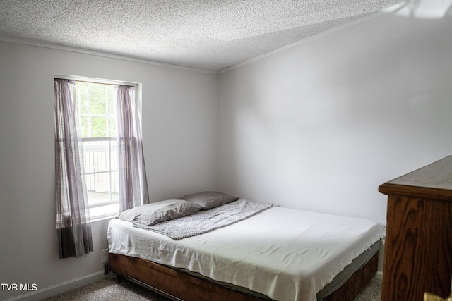 bedroom with a textured ceiling, carpet, and baseboards