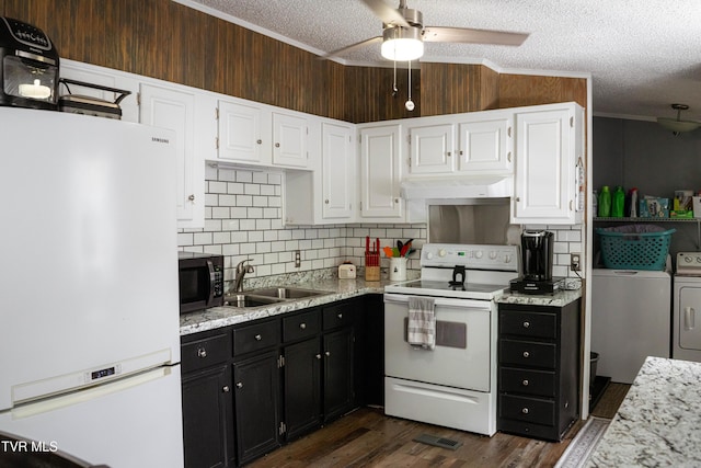 kitchen with a sink, washing machine and clothes dryer, white cabinetry, white appliances, and under cabinet range hood