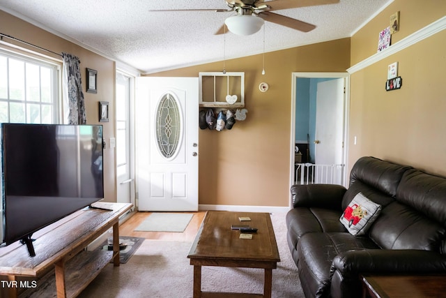 living room featuring a textured ceiling, lofted ceiling, and ceiling fan