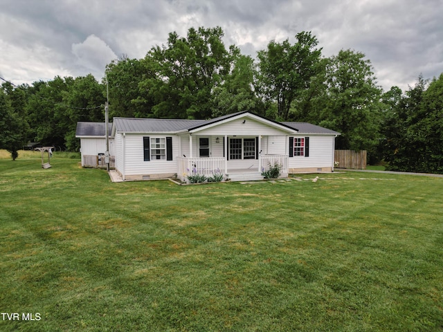 view of front of house with crawl space, fence, metal roof, a front lawn, and a porch