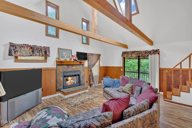 4331 Sentry Rd, Big Stone Gap, VA 24219 - living room with stairs, a wainscoted wall, high vaulted ceiling, light wood-style floors, and a fireplace