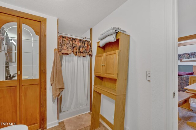 4331 Sentry Rd, Big Stone Gap, VA 24219 - full bath with a shower with shower curtain, tile patterned floors, and baseboards