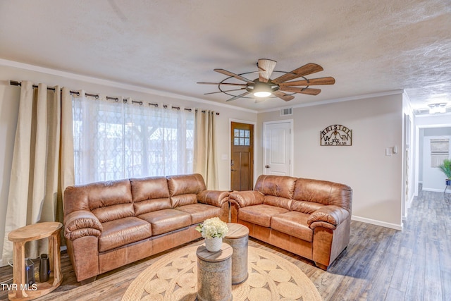 living room with crown molding, baseboards, wood finished floors, and a ceiling fan