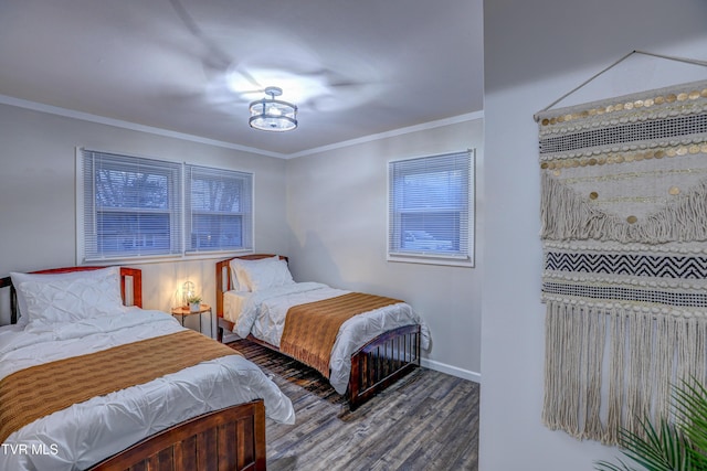 bedroom with crown molding, baseboards, and wood finished floors