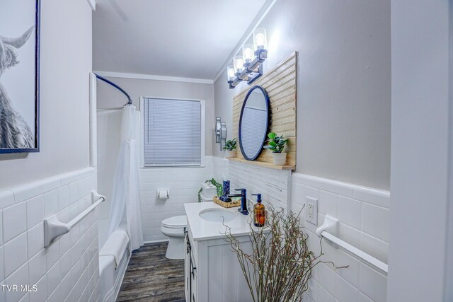2133 Veda Dr, Bristol, VA 24201 - bathroom featuring tile walls, toilet, vanity, a wainscoted wall, and wood finished floors